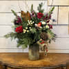 Red roses, blue thistle, burgundy snapdragons, white button chrysanthemums, white hypericum berries
