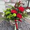 Fresh evergreens, carnations, button Poms and more designed in a small tin