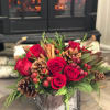 Send holiday greetings with rich reds hues and seasonal textures like pinecones