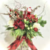 A premium vased arrangement of a dozen warmly hued roses and seasonal
