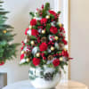 

Bring home the holiday cheer with this festive glass vase arrangement featuring