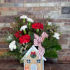 A super cute wooden box with a gingerbread house front, is filled