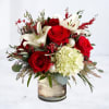 Inspired by the quiet beauty of winter gatherings, the Hollybrook arrangement pairs