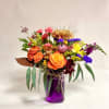 This vibrant arrangement captures the warmth and richness of the fall season.