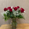 A true classic- a dozen long-stemmed red roses arranged tall and showy