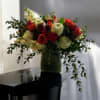 A beautiful mix of roses, ranunculus, eucalyptus, and more in warm fall
