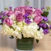 A Spring mix of lavender tulips, purple hyacinth, and hydrangea in a