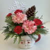 Red/White Carnations, Pixie Carnations, Assorted Winter Greens in a Santa Mug Accented