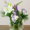 Three different sized bud vases feature a hand-crafted mix of fresh seasonal