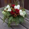 Bring a little Christmas cheer into any household with this seasonal arrangement!
