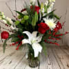 Brighten your holidays with this fresh arrangement featuring elegant lilies, vibrant roses