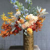 Cheerful, vibrant, and full of character, this medium&ndash;tall arrangement is crafted to
