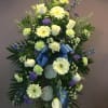 A beautiful spray of flowers such as blue delphinium, white roses, green