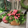 A basket bursting with Christmas greens and holiday decor bring the heavenly