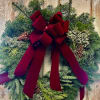 This 26in large fresh wreath comprised of Balsam, Cedar, and Juniper accented