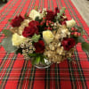 This cheerful holiday pieces includes hydrangea, roses, spray roses, ranunculus and hypericum