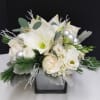 A matte silver cube with hydrangea, white amaryllis, white roses, lisianthus, dusty