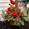 Fresh holiday arrangement that includes; roses, carnations, mini carnations, millimeter balls, pine