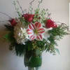 White hydrangea, red roses, amaryllis and seasonal foliage. 