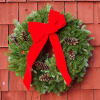 Beautiful full evergreen wreath. Adorned with pine cones and a bow. Made