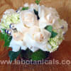 Snowy white roses and fluffy hydrangeas are paired with fresh holiday greens