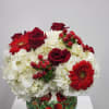 Select this lovely white and red arrangement with a ceramic cardinal designed