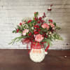Santa pitcher filled with festive Christmas florals 