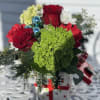 Ceramic present filled with red roses, carnations, green hydrangeas and white 
chrysanthemums