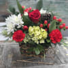 A charming sleigh filled with red roses, carnations, red hypericum berries, green