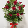 This stunning bouquet features a dozen premium red roses, complemented by delicate