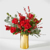 Striking red roses, berries and delightful holiday greens make for an exquisite