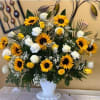 Adorning a pedestal basket, this beautiful arrangement is a mix of sunflowers