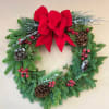 24&quot; Mixed greenery Christmas wreath with pinecones, red berries and a red