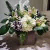 a beautiful mix  with cymbidium orchids and roses white lilies 