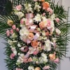 Peach and white funeral spray with mums, mini carnations, carnations, roses, stock