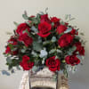 1dozen beautifully arranged roses in a case surrounded with baby&#039;s breath. Shown