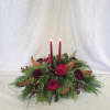 This timeless Christmas centerpiece blends lush Christmas greens with velvety red roses