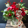 Christmas centerpiece filled with the colors of the season.