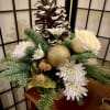 This beautiful holiday arrangement is a gold-colored chalice container with a large
