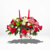 A dazzling double candlelight Christmas centerpiece, decked out with vibrant red roses