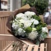 White roses, white stock, white Fuji mums, white lilies, and assorted greenery