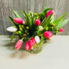 Small cube style vase with pink and white tulips and hypericum berries.
