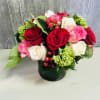 Roses in pink, red and white with red hypericum berries and hydrangeas