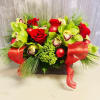 Brown box arrangement with cymbidium orchids, roses, ornaments, bows and pine. 