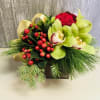 Simple seasonal cube arrangement in shades of reds and greens, gold ribbon