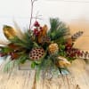 This beautiful, long arrangement is nature inspired with fresh Christmas greenery, lotus