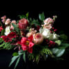 A lively arrangement in holiday colors that is anything but traditional. In