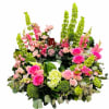 A beautiful selection of floral blooms adorns this memorial urn wreath lifting