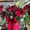 The Evergreen Holiday Charm Box is a festive, lush Christmas arrangement overflowing