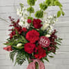 A holiday tradition, wrapped up into a Christmas Floral arrangement. Featuring the